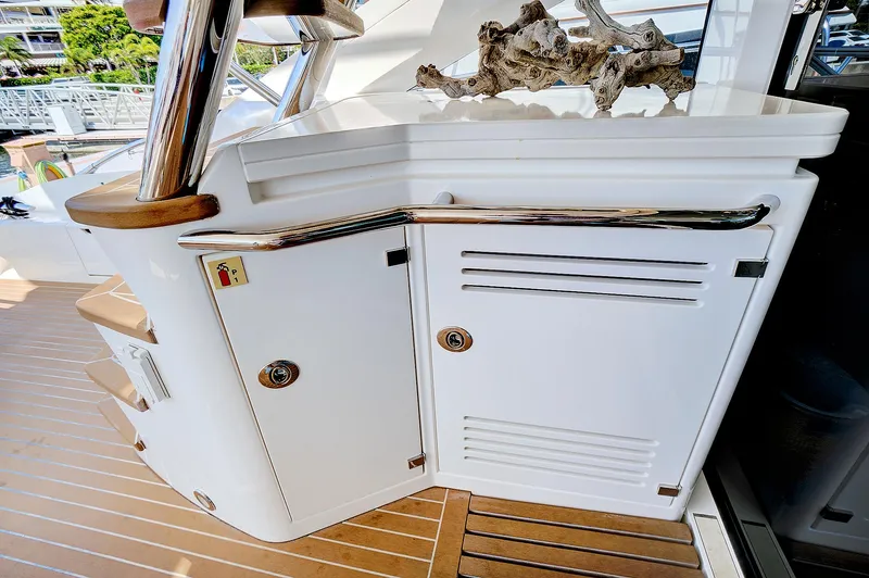 Slide: The Image of 2017 Sunseeker 68 Sport Yacht deck with storage cabinets and stairs. - 17