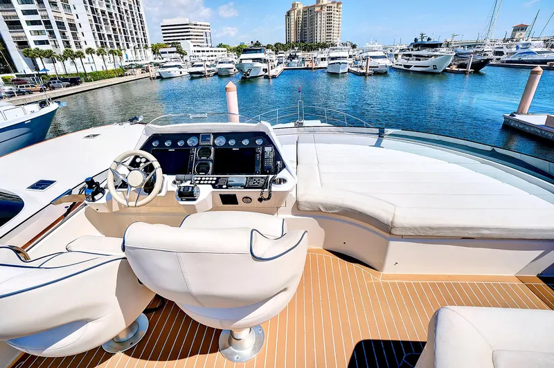Slide: The Image of 2017 Sunseeker 68 Sport Yacht helm station with marina view. - 21
