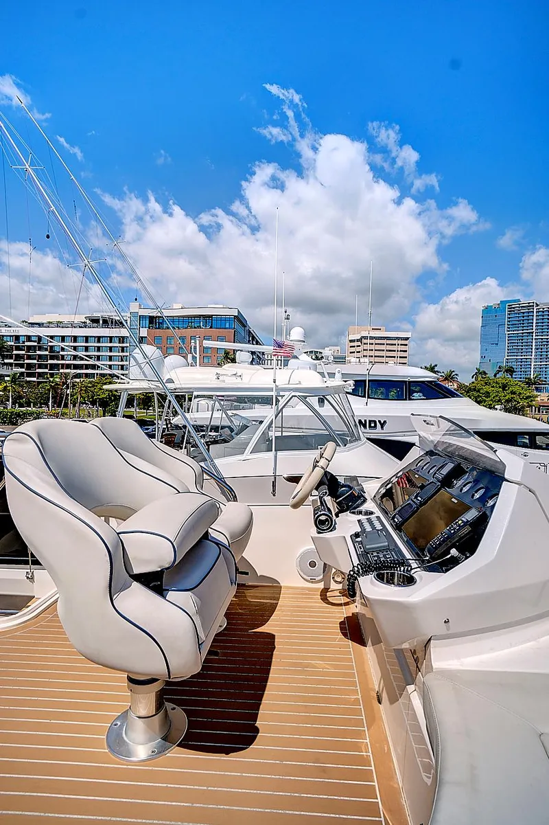 Slide: The Image of 2017 Sunseeker 68 Sport Yacht helm station with modern controls and luxurious seating. - 22