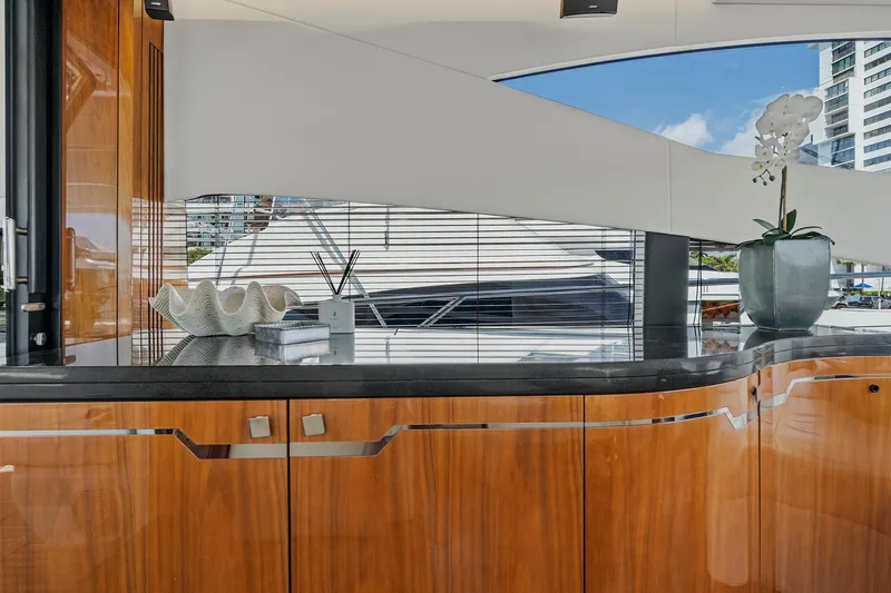Slide: The Image of Interior of 2017 Sunseeker 68 Sport Yacht with polished wood cabinetry and modern decor. - 33
