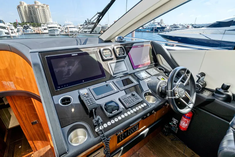 Slide: The Image of 2017 Sunseeker 68 Sport Yacht helm with advanced navigation systems and luxurious design. - 37