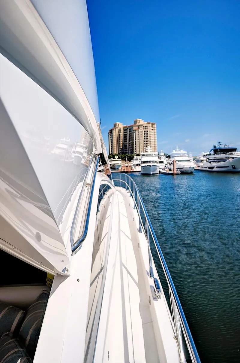 Slide: The Image of 2017 Sunseeker 68 Sport Yacht docked in a marina with other boats. - 4