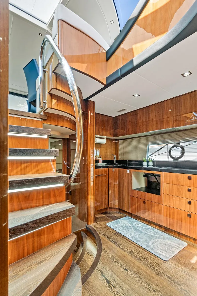 Slide: The Image of 2017 Sunseeker 68 Sport Yacht interior with modern kitchen and spiral staircase. - 41