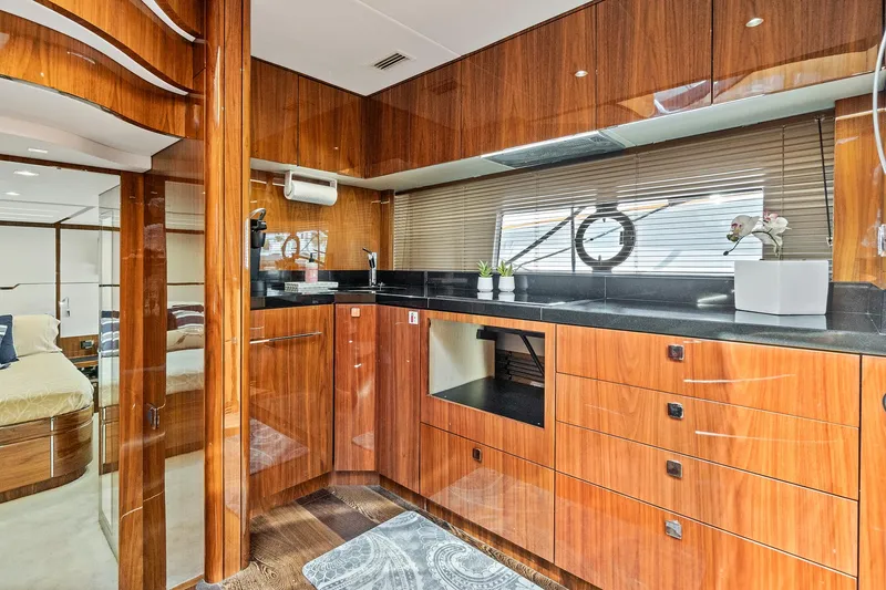 Slide: The Image of Luxurious kitchen interior of 2017 Sunseeker 68 Sport Yacht with wooden cabinetry and modern appliances. - 42