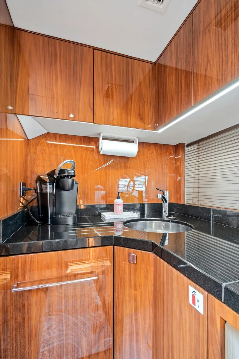 Slide: The Image of 2017 Sunseeker 68 Sport Yacht kitchen with wood cabinetry and modern appliances. - 43