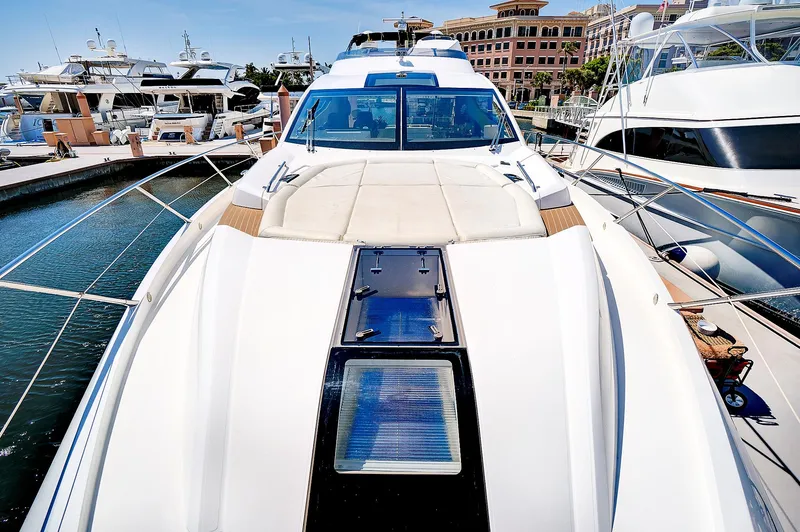 Slide: The Image of 2017 Sunseeker 68 Sport Yacht docked at a marina, showcasing its sleek design. - 9