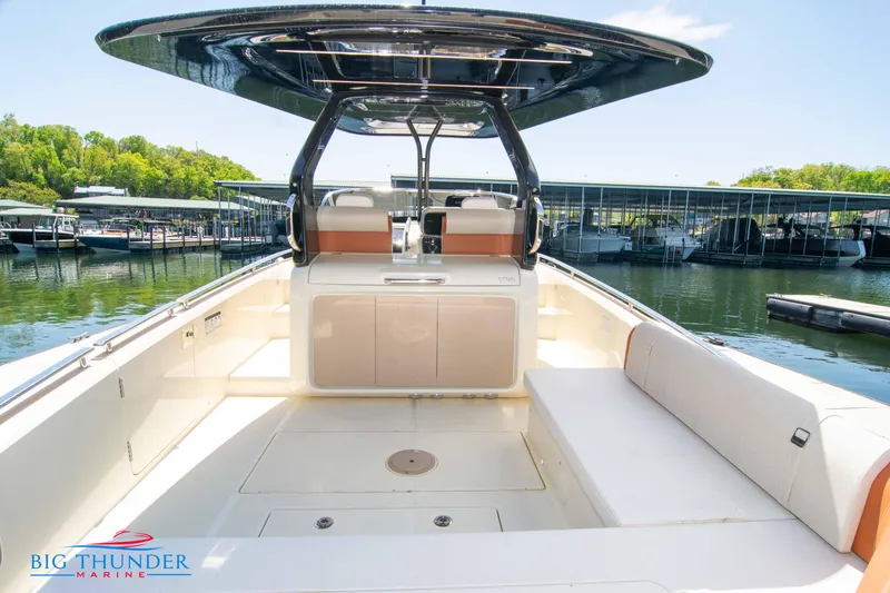 Slide: The Image of 2024 Invictus GT320S boat interior at marina, featuring spacious seating and modern design. - 11