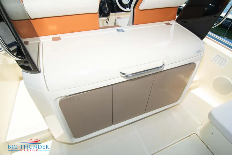 Slide: The Image of 2024 Invictus GT320S boat interior with storage compartment and seating. - 15