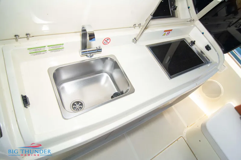 Slide: The Image of 2024 Invictus GT320S boat kitchen sink and counter area. - 16