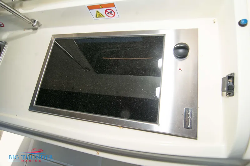 Slide: The Image of Invictus GT320S 2024 model stove with black glass top and stainless steel frame. - 17