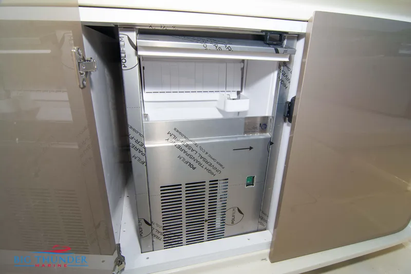 Slide: The Image of 2024 Invictus GT320S built-in ice maker in storage compartment. - 19