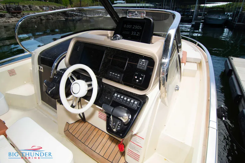 Slide: The Image of 2024 Invictus GT320S boat cockpit with steering wheel and control panel at Big Thunder Marine. - 26
