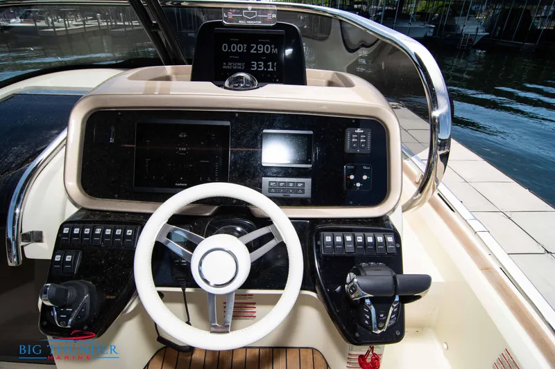 Slide: The Image of 2024 Invictus GT320S boat dashboard with steering wheel and control panel. - 27