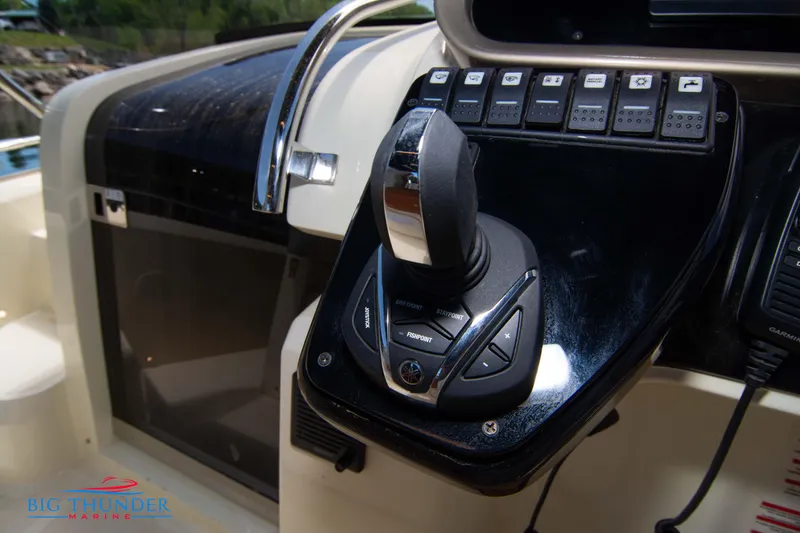Slide: The Image of Control panel of the 2024 Invictus GT320S boat with joystick and switches. - 37