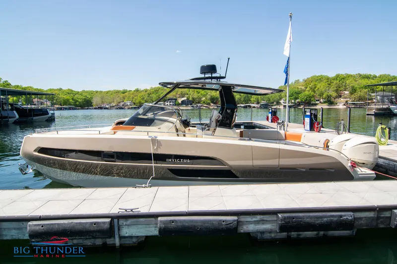 Slide: The Image of 2024 Invictus GT320S luxury boat docked at marina on a sunny day. - 4