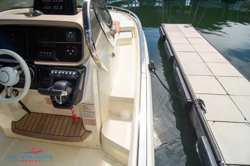Slide: The Image of 2024 Invictus GT320S boat interior with dockside view. - 43