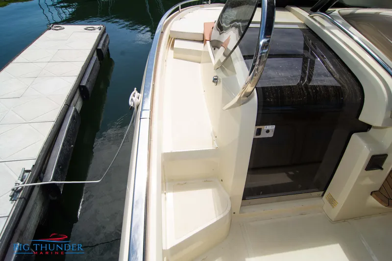 Slide: The Image of 2024 Invictus GT320S yacht docked, showcasing the deck and entryway. - 44
