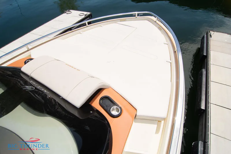 Slide: The Image of 2024 Invictus GT320S boat docked, showing spacious bow area and seating. - 46