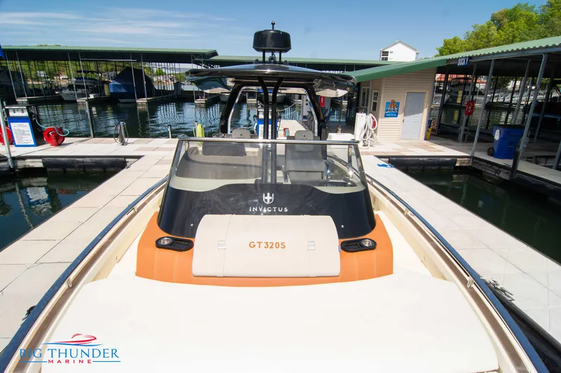Slide: The Image of 2024 Invictus GT320S luxury boat docked at marina. - 48