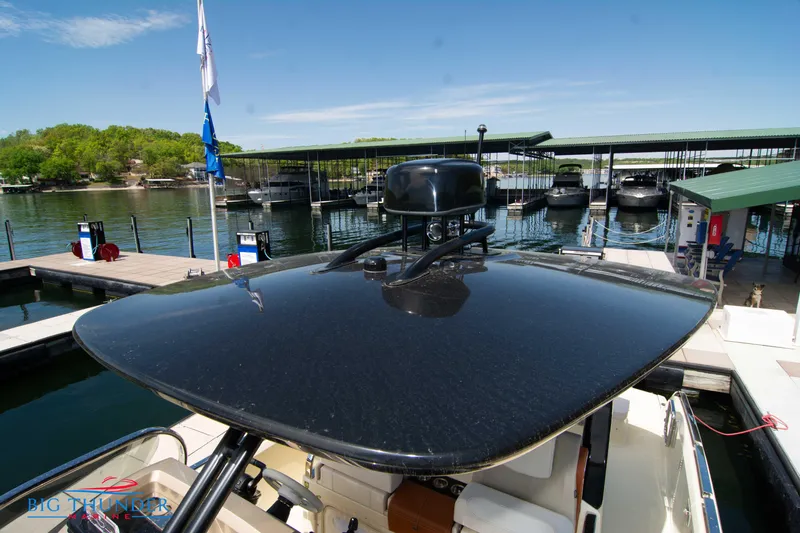 Slide: The Image of 2024 Invictus GT320S at marina dock with covered boat slips. - 49