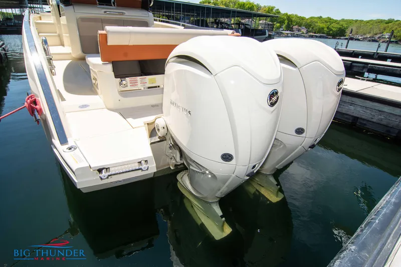 Slide: The Image of 2024 Invictus GT320S boat with dual outboard engines docked at Big Thunder Marine. - 6