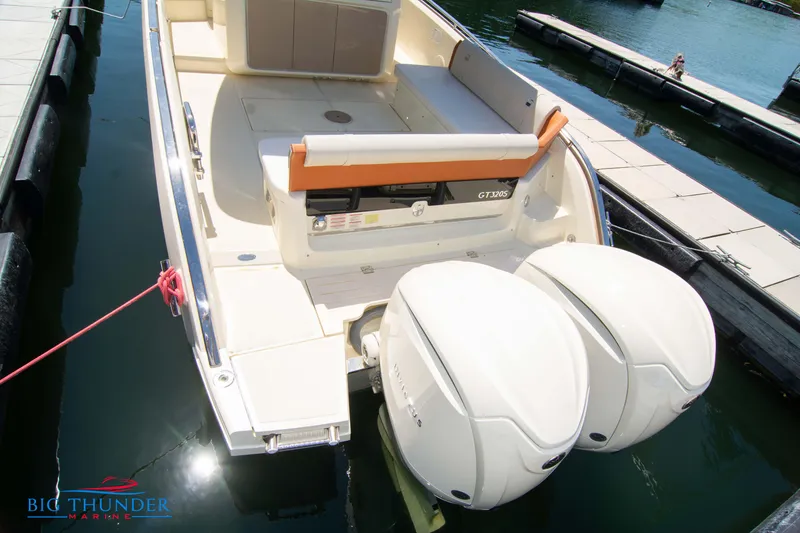Slide: The Image of 2024 Invictus GT320S boat docked with twin outboard engines. - 7