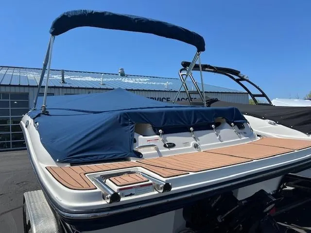 Slide: The Image of 2018 Sea Ray SPX 190 boat with blue cover and bimini top. - 3