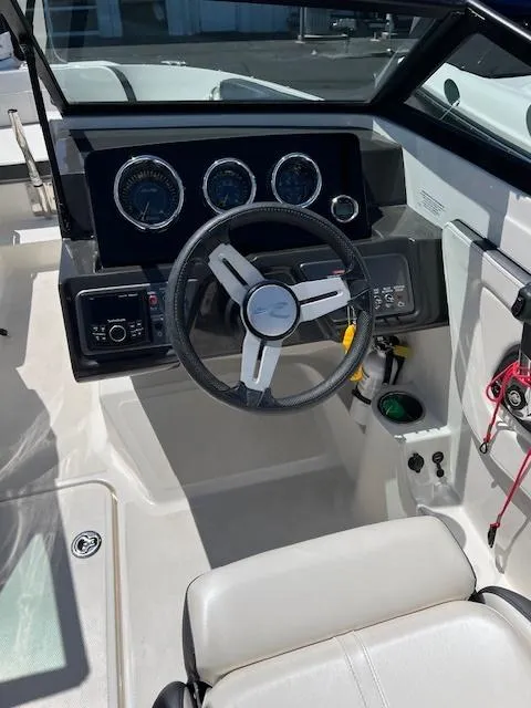 Slide: The Image of 2018 Sea Ray SPX 190 boat dashboard with steering wheel and gauges. - 6