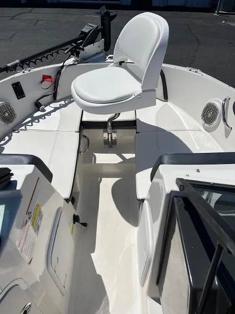 Slide: The Image of 2018 Sea Ray SPX 190 boat interior with white seating and modern controls. - 8