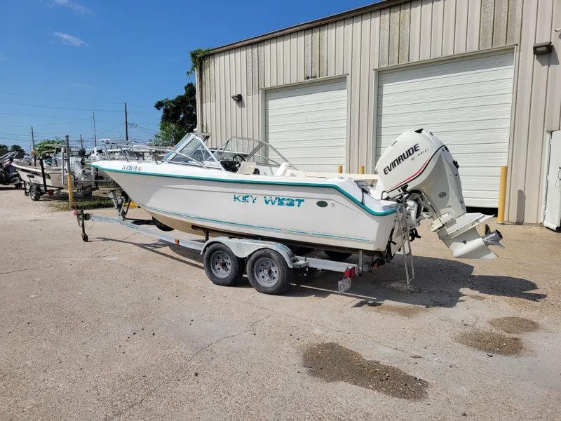 Slide: The Image of Key West 2020 Dual Console 2000 boat on trailer outside a warehouse. - 2