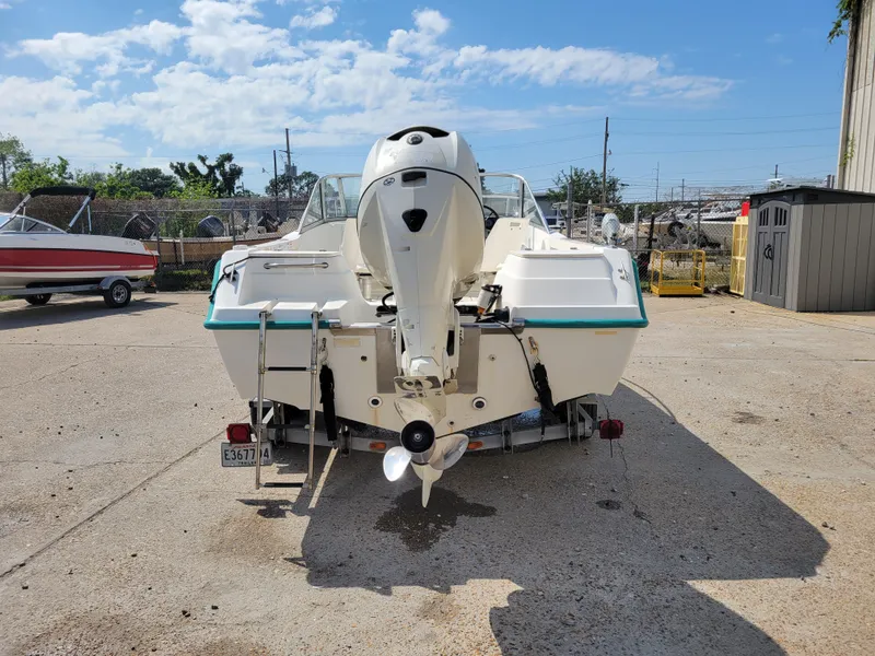 Slide: The Image of Key West 2020 Dual Console 2000 boat, rear view, parked outdoors on a sunny day. - 3