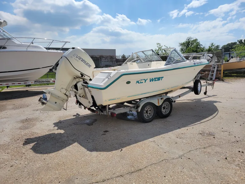 Slide: The Image of Key West 2020 Dual Console boat, 2000 model, on a trailer in a sunny outdoor setting. - 4