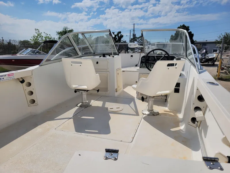 Slide: The Image of Key West 2020 Dual Console 2000 model boat interior with seating and steering wheel. - 7