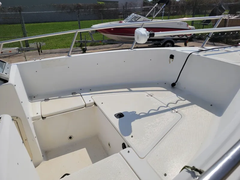 Slide: The Image of Key West 2020 Dual Console 2000 boat interior with seating and storage compartments. - 9