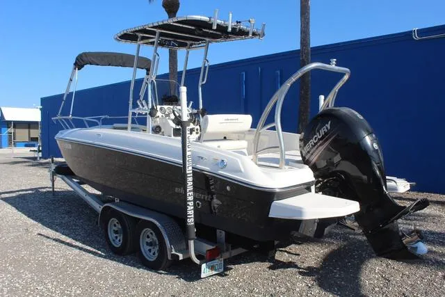 Slide: The Image of 2018 Bayliner Element F21 boat on a trailer in a gravel lot. - 7