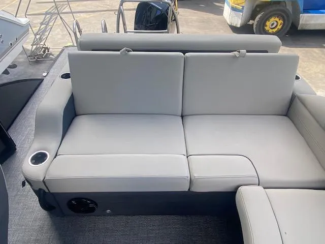 Slide: The Image of 2023 Barletta Cabrio 24 U boat interior with comfortable gray seating and cup holders. - 14