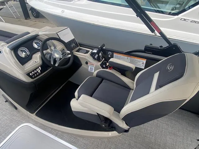 Slide: The Image of 2023 Barletta Cabrio 24 U boat cockpit with steering wheel and captain's chair. - 16