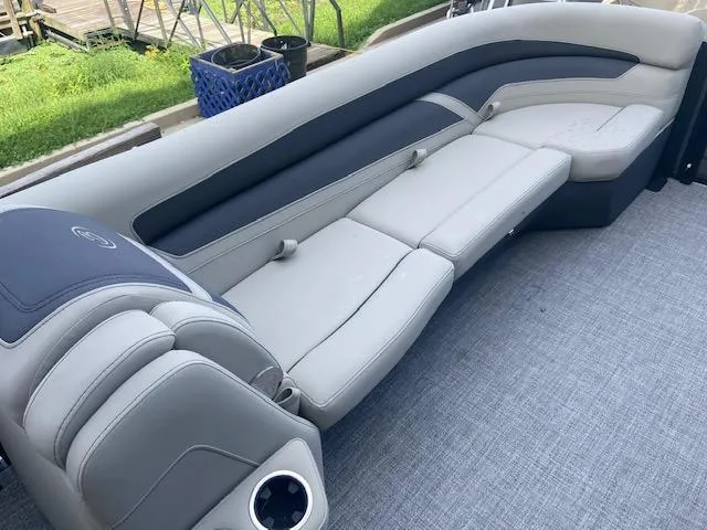 Slide: The Image of 2023 Barletta Cabrio 24 U boat interior with plush seating and cup holder. - 19