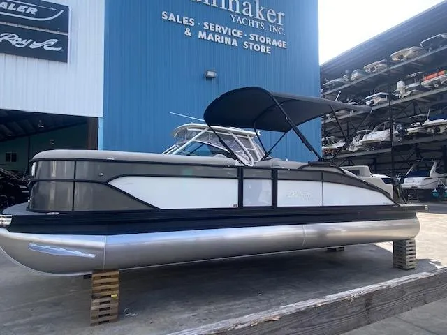 Slide: The Image of 2023 Barletta Cabrio 24 U pontoon boat at a marina storage facility. - 2