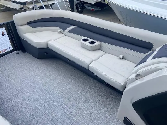 Slide: The Image of 2023 Barletta Cabrio 24 U boat interior with plush seating and cup holders. - 20