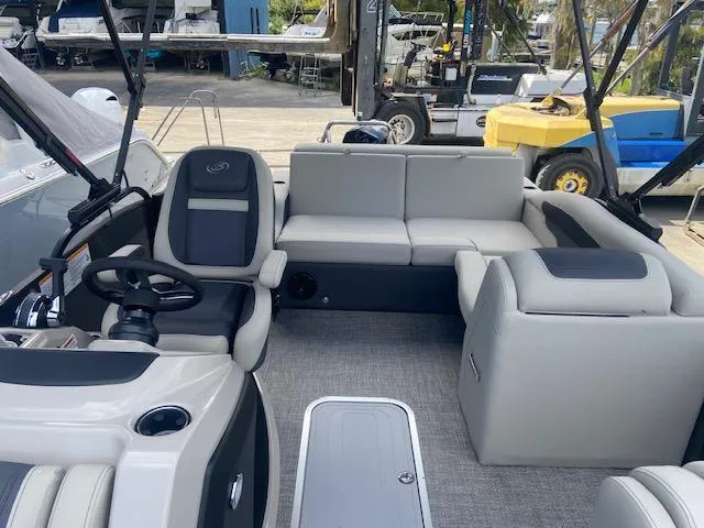 Slide: The Image of 2023 Barletta Cabrio 24 U pontoon boat interior with gray seating and steering console. - 21