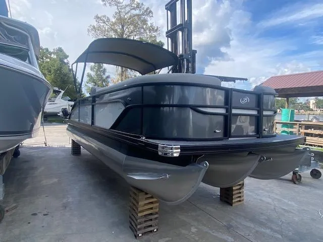 Slide: The Image of 2023 Barletta Cabrio 24 U pontoon boat on a dock, side view. - 6