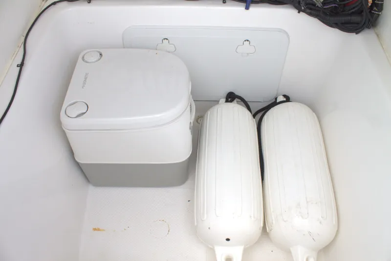 Slide: The Image of Portable toilet and fenders in the storage compartment of a 2019 Cape Horn 22 OS boat. - 14