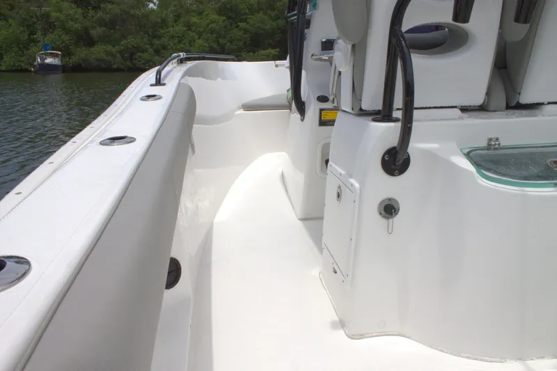 Slide: The Image of 2019 Cape Horn 22 OS boat interior, white deck and seating, near water. - 16