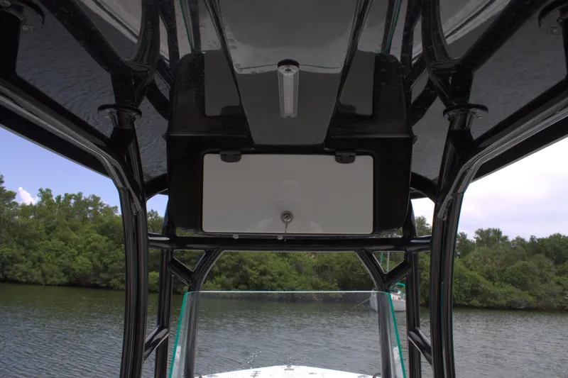 Slide: The Image of 2019 Cape Horn 22 OS boat interior view with overhead console and water background. - 19