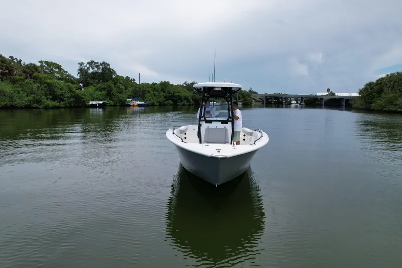 Slide: The Image of 2019 Cape Horn 22 OS boat cruising on a calm river near a bridge. - 2