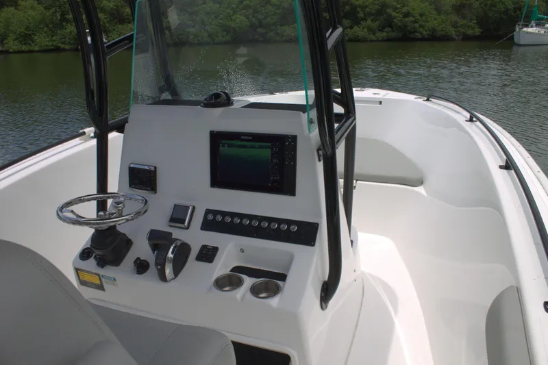 Slide: The Image of 2019 Cape Horn 22 OS boat console with steering wheel and navigation system. - 24