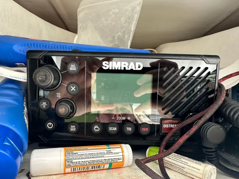 Slide: The Image of Simrad marine radio on a 2019 Cape Horn 22 OS boat, surrounded by boating equipment. - 26