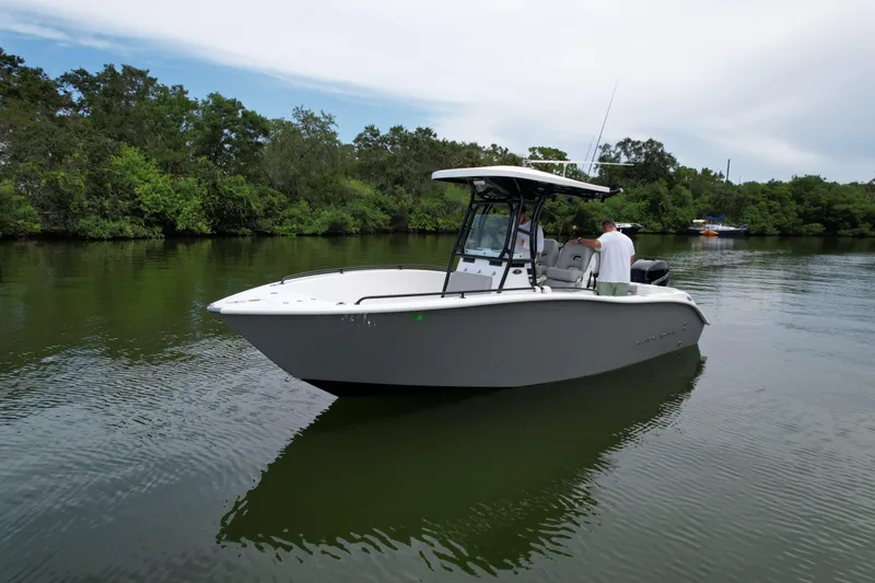 Slide: The Image of 2019 Cape Horn 22 OS boat on calm water with lush greenery in the background. - 3