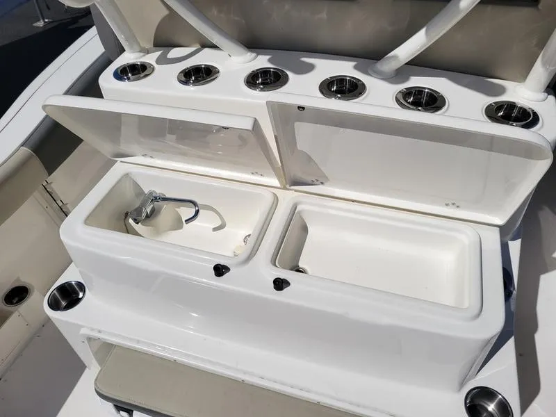 Slide: The Image of 2025 Key West 291 FS boat console with cup holders and storage compartments. - 13